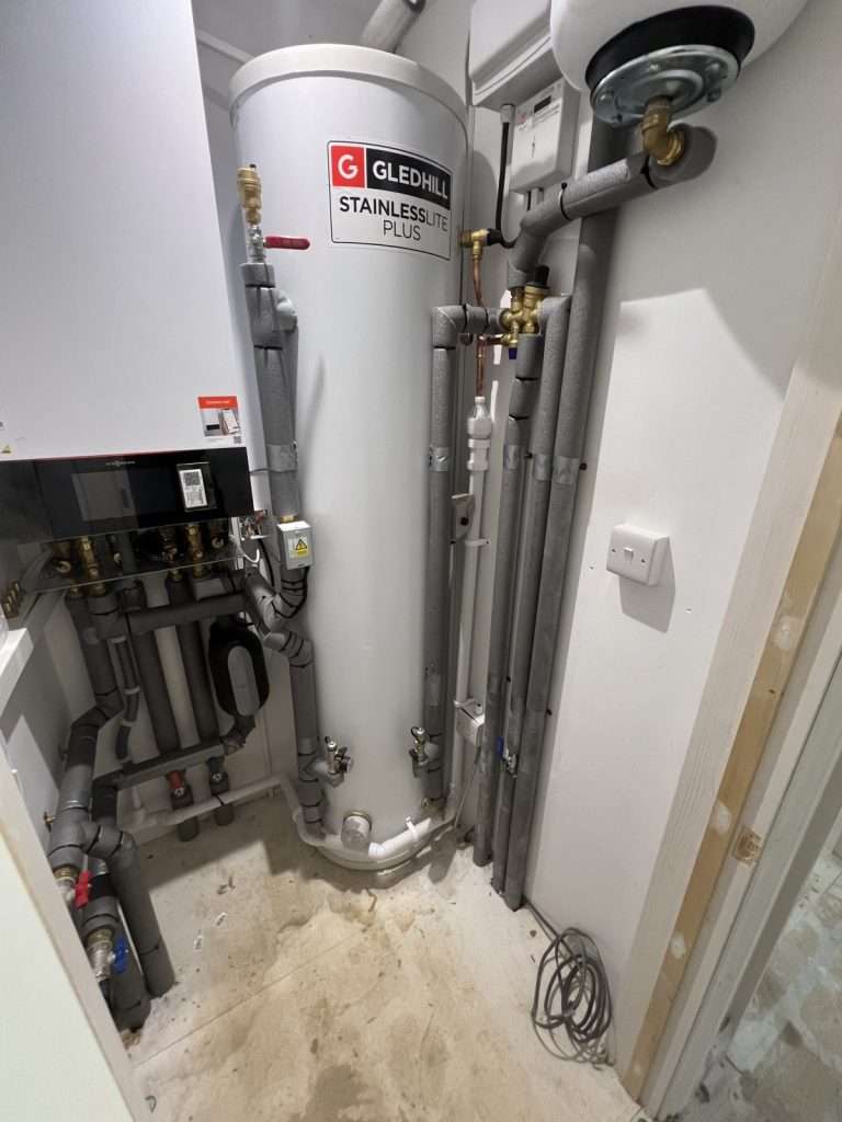 Heat pump cylinder and pipework in the airing cupboard of a new build in Timsbury, fitted by Bath Eco Heat